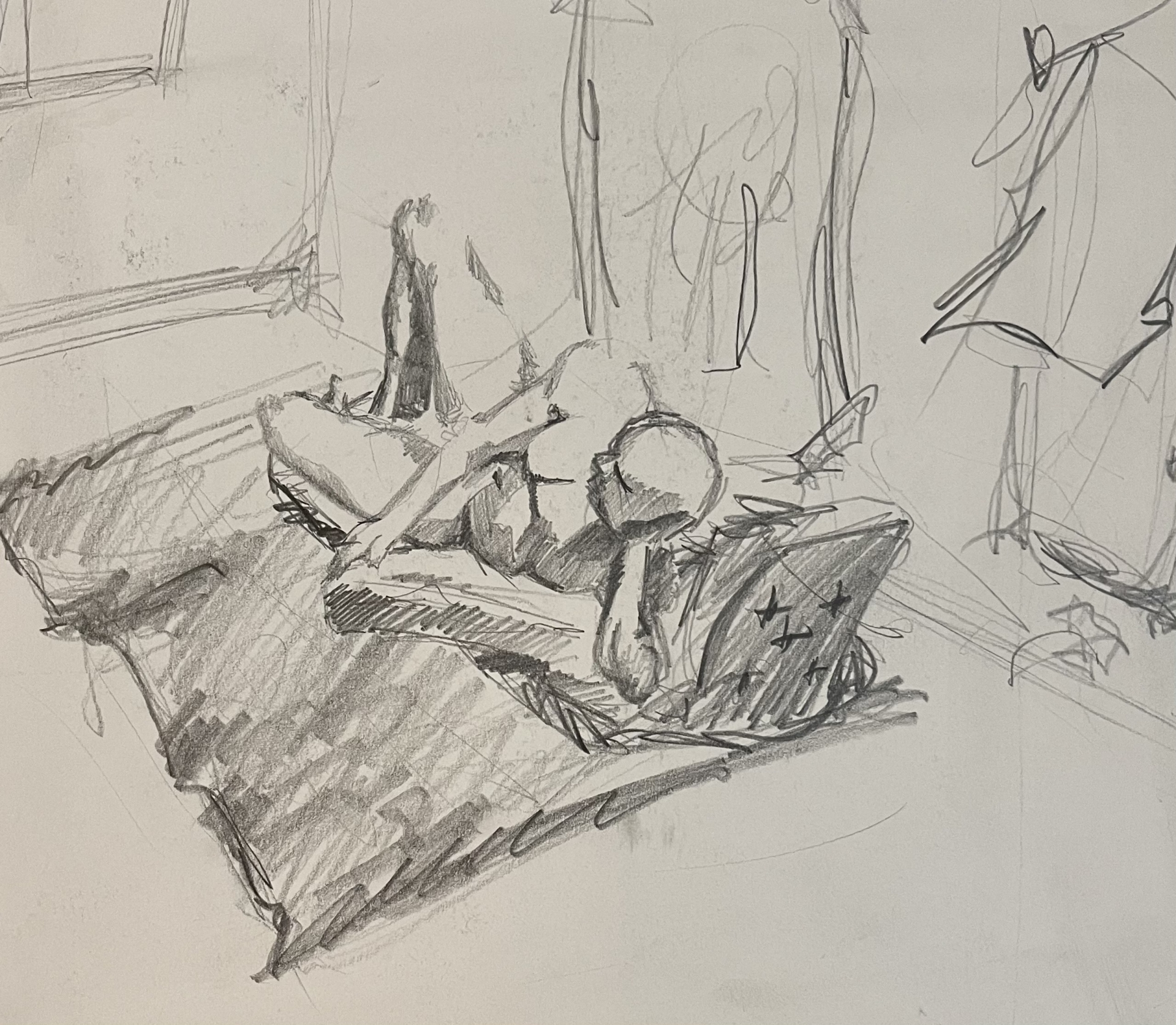 Pencil sketch of a man reclining on a blanket, seen from behind, with shadows capturing the relaxed posture.