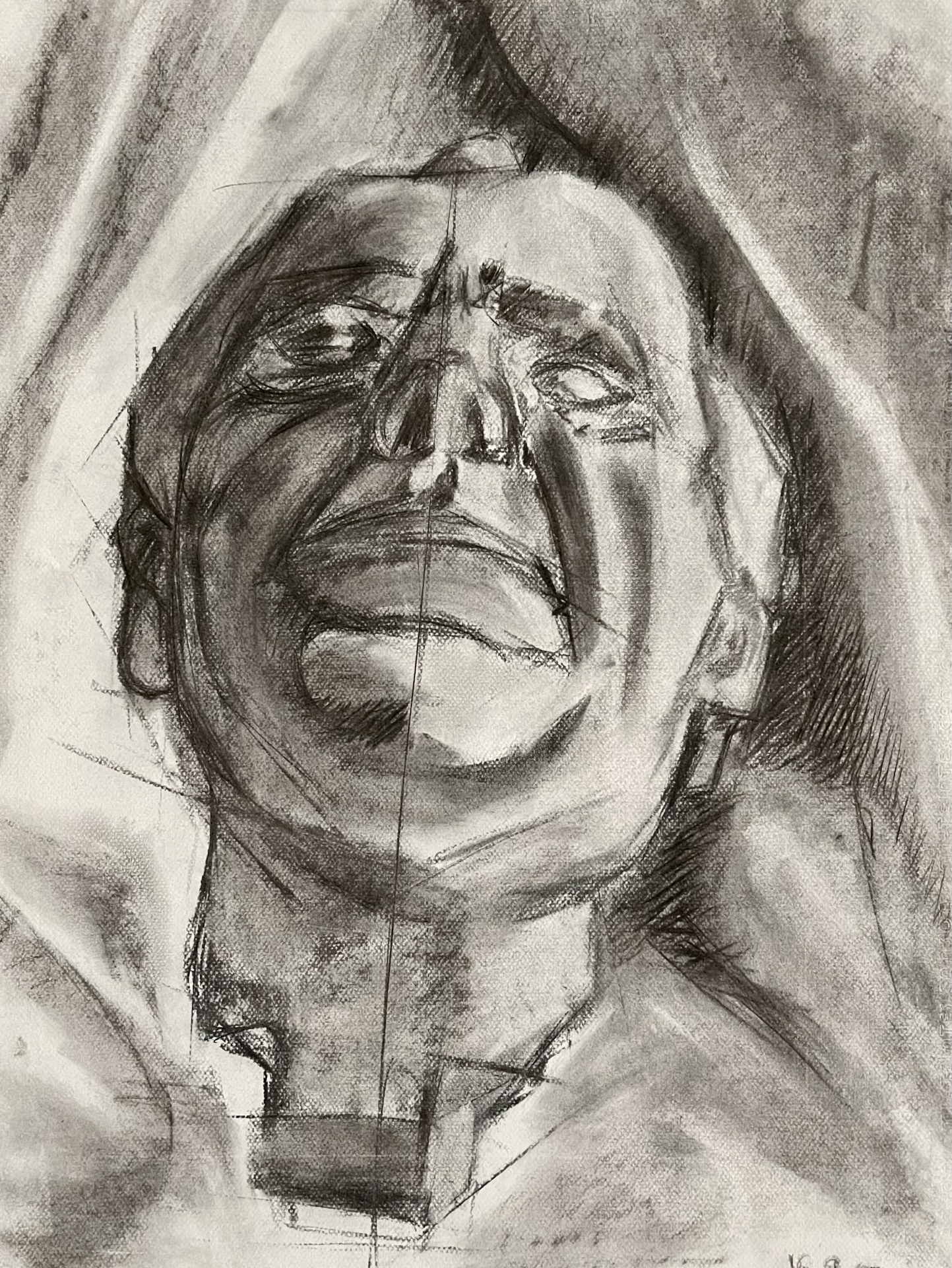 Charcoal drawing of a stone head sculpture, frontal view, emphasizing shadows and light on A1 Canson paper.